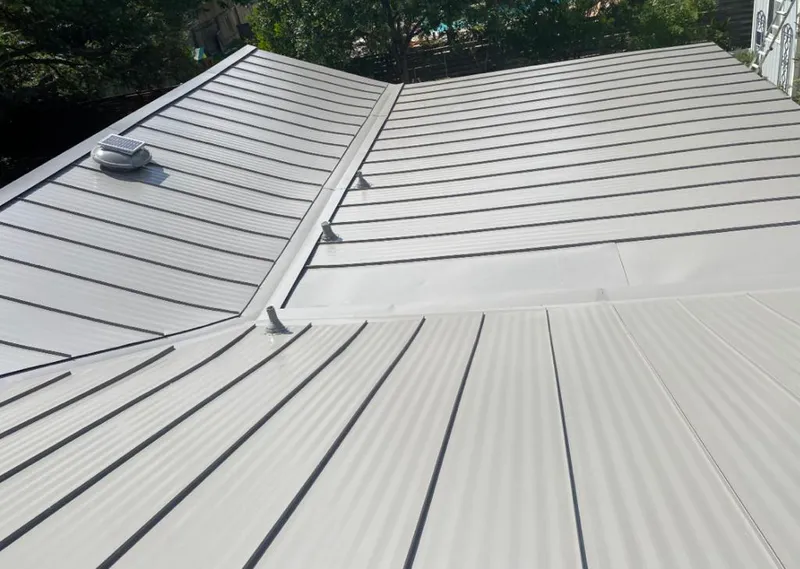 Solar attic fan installed on a metal roof for Roof Ventilation in River Park